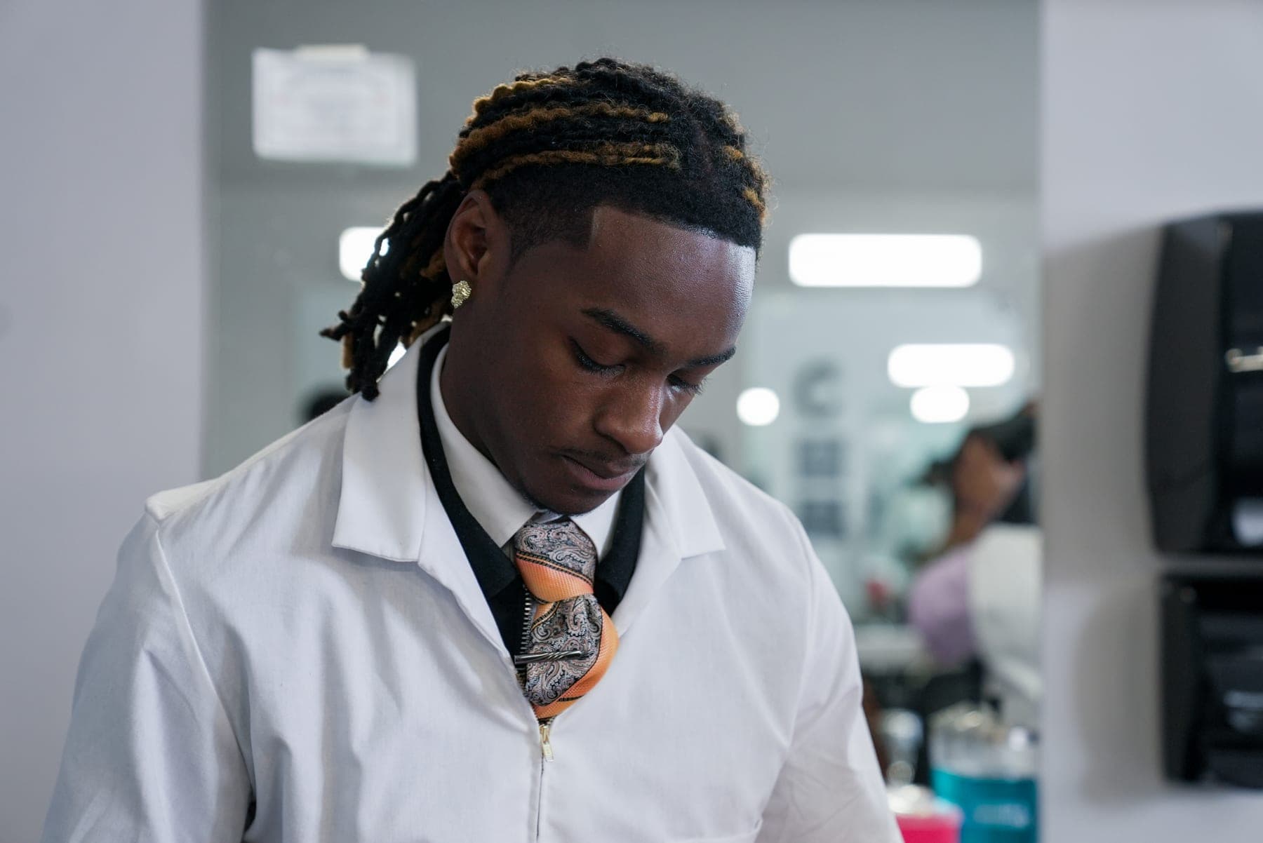Barbering student in uniform at Winston-Salem Barber School, brand photography by Lenny J Media